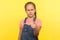 Hey you! Portrait of bossy little girl in denim overalls pointing to camera and looking with angry displeased expression