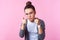 Hey you! Portrait of sophisticated brunette teenage girl in round eyeglasses pointing at camera. pink background