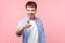 Hey you! Portrait of young joyous brown-haired man laughing, looking at camera. isolated on pink background