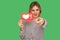 Hey you, put like to content! Pretty girl with red lips in glamour striped blouse holding social media heart icon