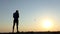 Hi-tech man operates a new flying drone at sunset in slo-mo