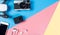 Hi tech travel gadget accessories on blue and pink copy space with drone action camera
