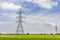 Hi-voltage electrical pylons against blue sky