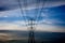 Hi-voltage electrical pylons against blue sky background