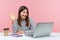 Hi you! Friendly positive woman office worker in striped shirt waving hand saying hello, sitting at workplace, secretary welcoming