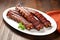 hickory smoked ribs on white plate, shot from birds-eye view