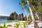 Hidden beach with first tourist trip boats in morning sun light at El Nido, Palawan, Philippines