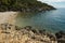 Hidden beach near Olive Gardens of Lun with thousands years old olive trees, island of Pag