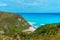 Hidden picturesque Caribbean Bay, azure sea and green cliffs