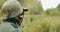 Hidden Re-enactor Dressed As German Wehrmacht Infantry Soldier In World War II Soldier Sitting In Ambush In Autumn