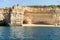 Hidden remote beach covered with limestone walls. Kayak left on the beach by tourists went for cave exploring. Algarve Portugal