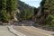 Hidden road in the mountains of arizona in the wild west with yellow and white lines on asphalt with trees and blue sky