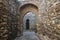 Hidden stone passageway in Malaga fortress with archs and gate