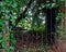 Hidden wrought iron gate to a secret garden, Welwyn Village, England