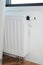 Hide Radiator Pipes. White radiator heating with thermostat for energy saving in house room and hidden heat pipes under the floor