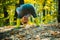 Hide and seek. Child having fun in forest. Forest school is outdoor education. Visit natural spaces. Boy in rubber boots