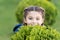 Hide and seek fun. Girl cute smiling kid green grass background. Healthy emotional happy kid relaxing outdoors. What