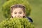 Hide and seek fun. Girl cute smiling kid green grass background. Healthy emotional happy kid relaxing outdoors. What