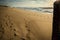 Hiding and watching behind blockhouse on scenic sandy beach and waves of atlantic ocean