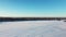 High aerial drone view flying very slowly backward over the frozen river at Berges-des-quatre-vents in Laval-Ouest and showing the