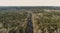 High aerial drone view of an railroad across the spring forest. Rural places