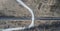 High aerial drone view of an railroad across the spring forest. Rural places