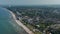 High aerial drone view of sensational summertime tourist beach in Scharbeutz, Germany, dolly in, sunny windy day