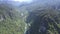 High aerial flight above canyon landscape with river road