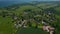 High aerial view circling around small suburbs residential area in Brodten, Germany, day