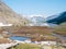 High altitude alpine landscape with majestic rocky mountain peaks. Aerial panorama at sunrise. Alps, Andes, Himalaya concept