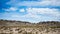 High altitude flowing stream in harsh barren landscape with scenic dramatic sky. Wide angle view from above at 4000 m on the Andea