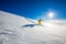 High altitude mountain explorer walking through deep snow