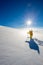 High altitude mountain explorer walking through deep snow