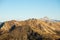 High altitude pasture, rocky mountain peaks and jagged ridge, with scenic sky, the Italian Alps. Expansive view in backlight. Tone