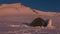 High-altitude tent in an assault camp on the Elbrus plateau at sunset