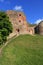 High, ancient fortress wall in summer, green grass and blue sky