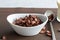 High angel view of chocolate cereal in a white bowl on brown background