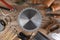 High angle closeup of a large group of tools arranged around a round table saw blade