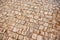 High angle closeup shot of a cobblestone ground with square beige tiles