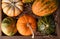 High angle closeup shot of a group of autumn gourds, squash and pumpkins in a wood box