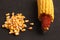 High angle closeup shot of a pile of peeled yellow corns on a black background