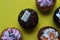 High angle closeup shot of small cupcakes with colorful creams