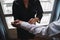 High angle closeup shot of a woman adjusting white shirt sleeves of a man