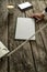 High angle closeup view of male hand holding a pen leaning on wooden office desk