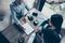 High angle cropped photo of family making a deal with lawyer about their business in cafe with cups of coffee. Men is going to si