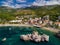 High-angle drone shot of Przno beach with the resort view, forested mountains, blue sky background