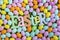 High angle of Easter banner letters surrounded by colorful Easter eggs