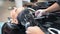 High angle female hands of professional hairdresser washing woman hair forming lathering