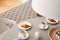 High angle on grey table with cups and croissants in scandi dining room interior. Real photo