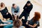 High angle of a group of teenagers sitting in a circle during ps